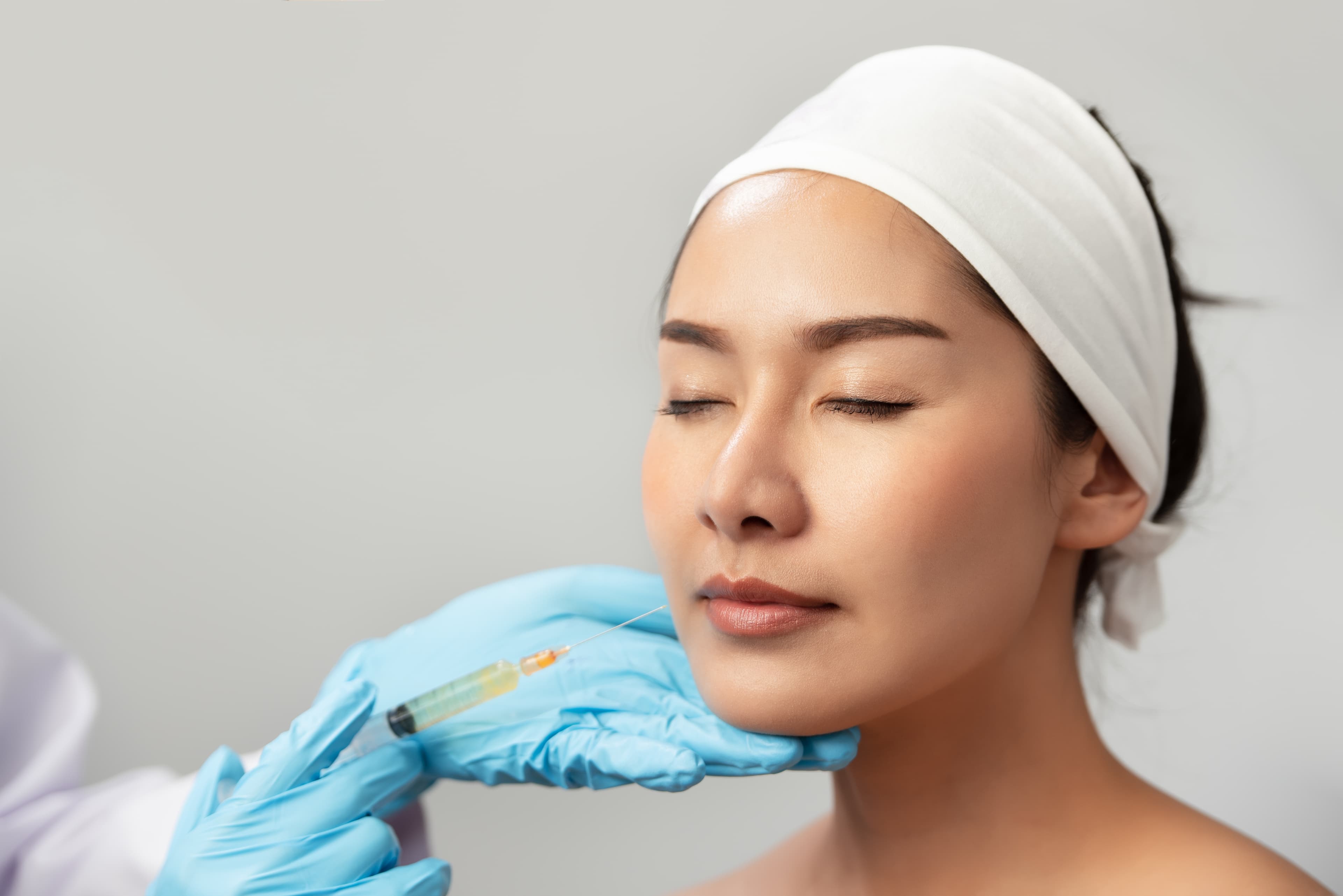 A patient receiving a dermal filler injection in the lower face