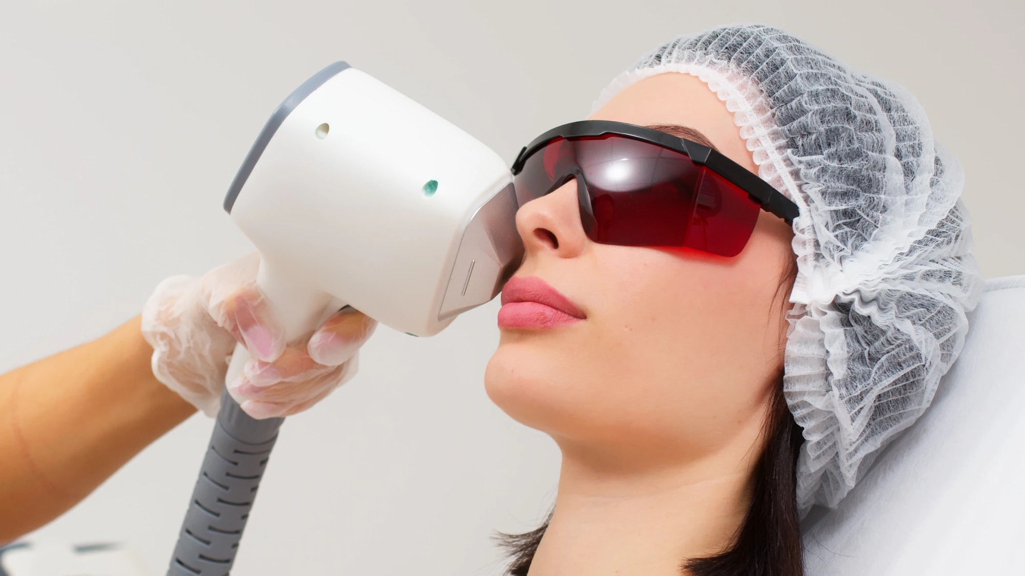 A client wearing protective eyewear during an IPL or BBL light-based photofacial treatment