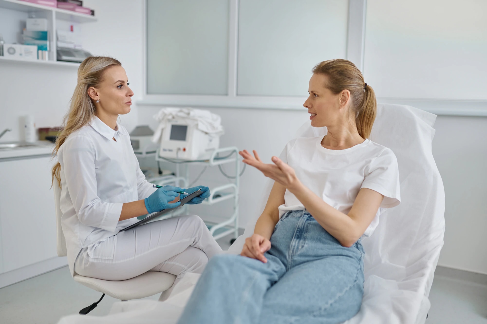 A cosmetic injector and a client talking through a Botox® or filler treatment plan